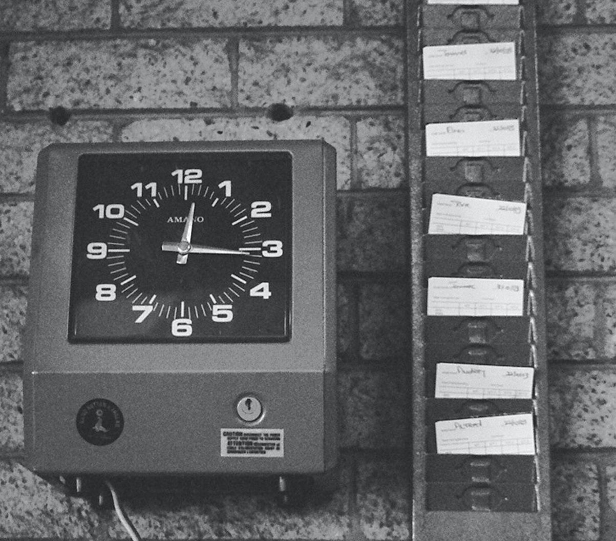 Variation to Contracted Hours - Black and white picture of an old fashioned clocking timecard machine