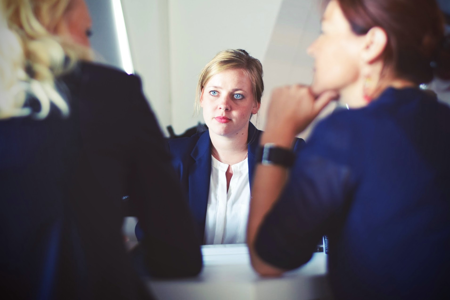 Navigating Redundancy: Guide for Employers image of a woman talking to two other women on each side of the table